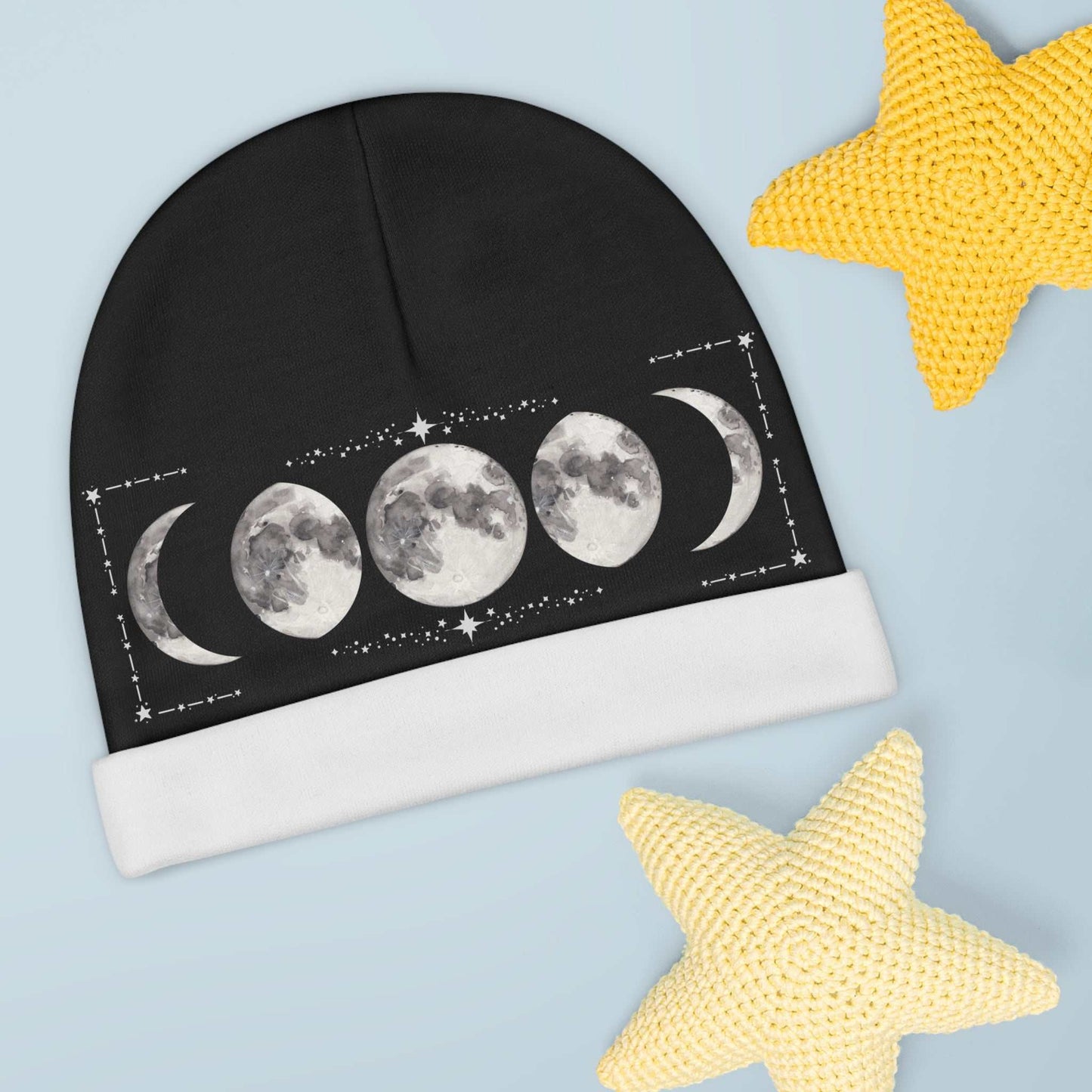 Moon phases baby beanie with celestial design on a soft, black fabric, ideal for newborns.