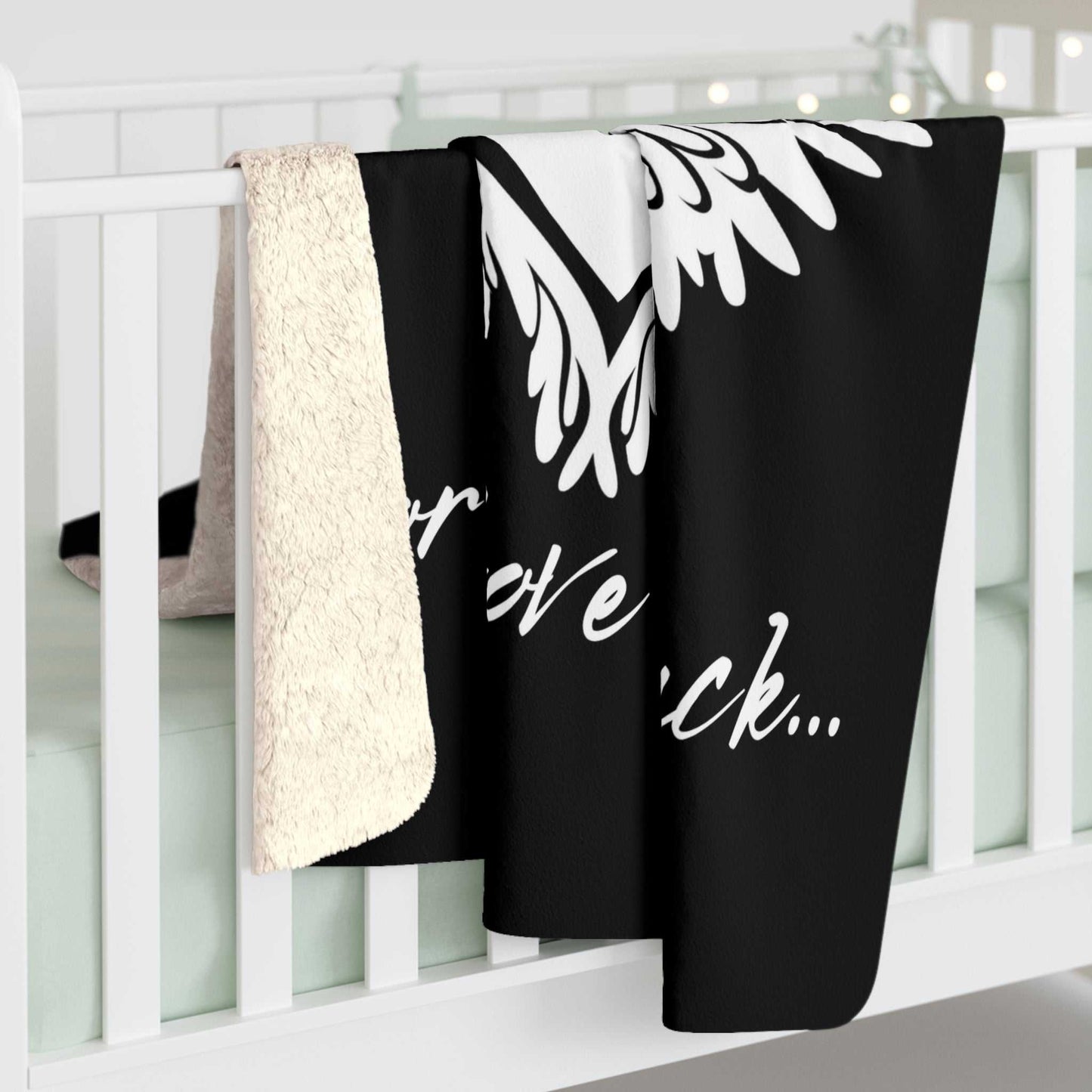 Black and white Stylish Sherpa Fleece Blanket with soft sherpa backside draped over white crib railing