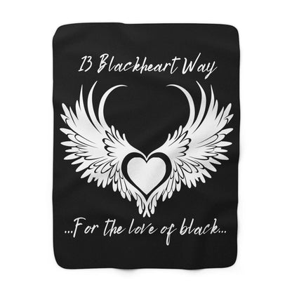 Blackheart logo Stylish Sherpa Fleece Blanket in black with white winged heart design and text, cozy and soft for warmth and decor.