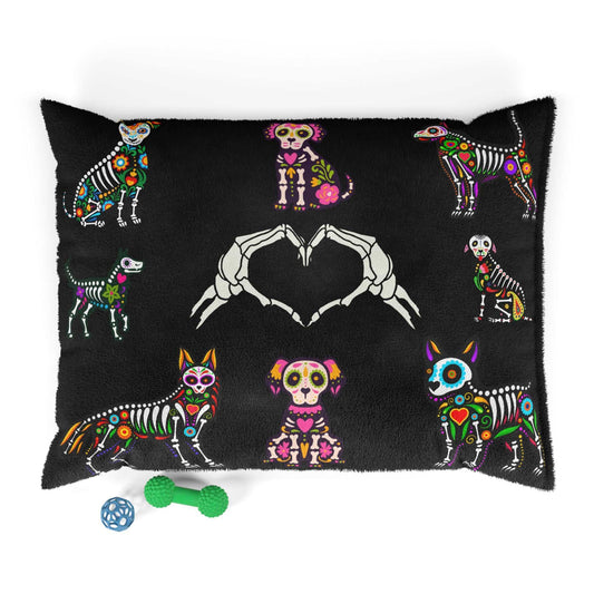 Black dog bed with colorful dog-themed sugar skulls and heart-shaped skeleton hands design on plush fabric