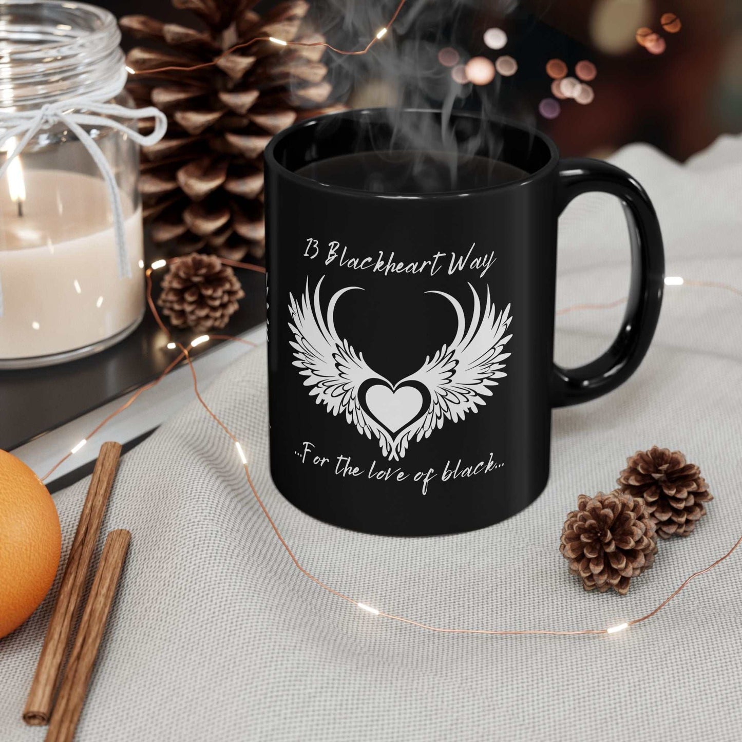 Black ceramic mug with Blackheart logo, available in 11oz or 15oz sizes, featuring a glossy finish, and safe for microwave and dishwasher use.