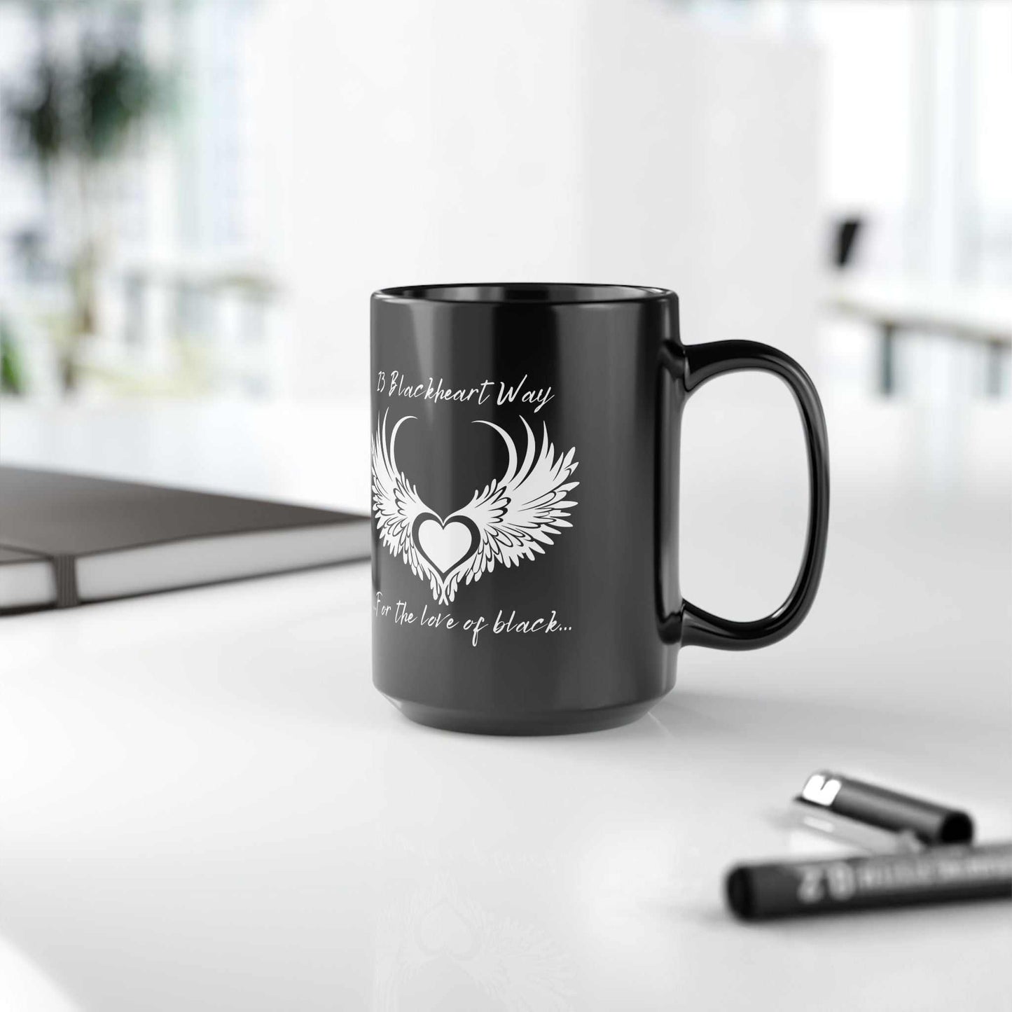 Black ceramic mug with Blackheart logo design, available in 11oz and 15oz sizes, microwave and dishwasher safe.