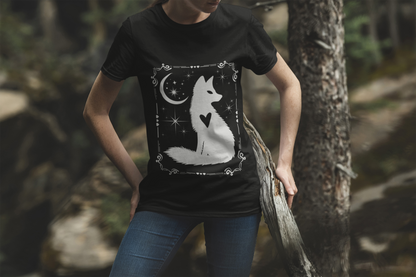 Black short sleeve tee with white celestial fox design, featuring a moon, stars, and a heart detail, worn casually outdoors.