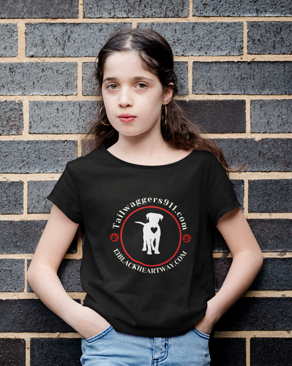 Child wearing black Tailwaggers 911 Kids Heavy Cotton Tee with white dog and red circle logo standing against brick wall