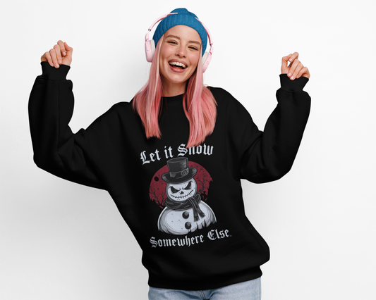Let It Snow Somewhere Else Sweatshirt with gothic snowman graphic and vintage horror lettering worn by smiling woman with pink hair and blue beanie
