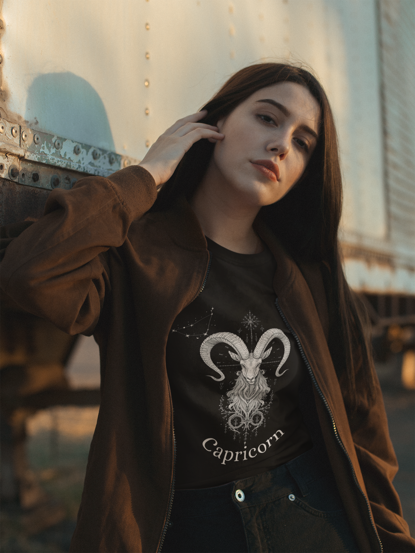 Young woman wearing Ambitious AF Capricorn Tee with skeletal sea-goat and constellation design outdoors