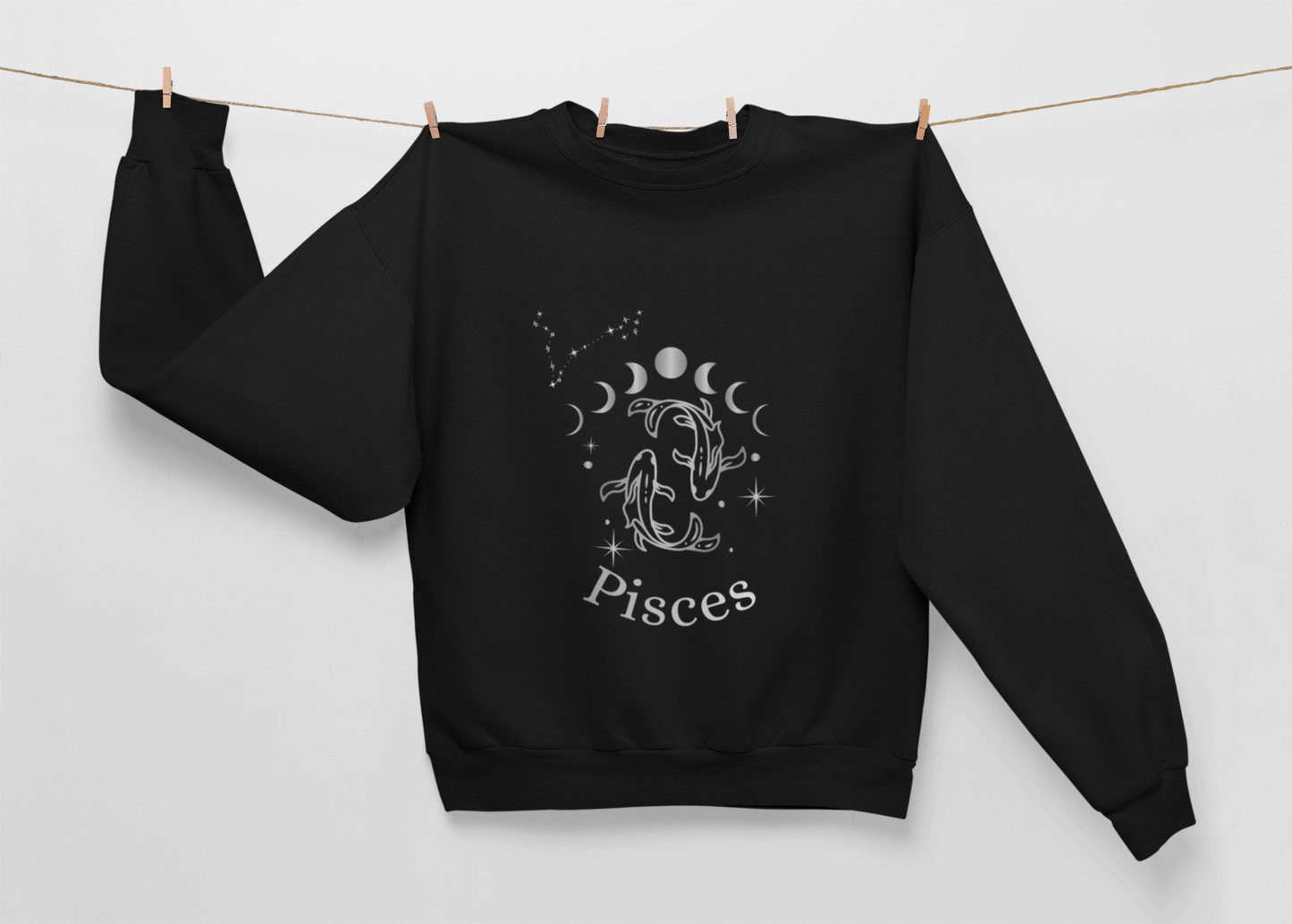 Black Ethereal Exile Pisces sweatshirt with silver-ink Pisces fish, moon phases, and constellation design, heavyweight cotton-poly blend with brushed fleece lining.