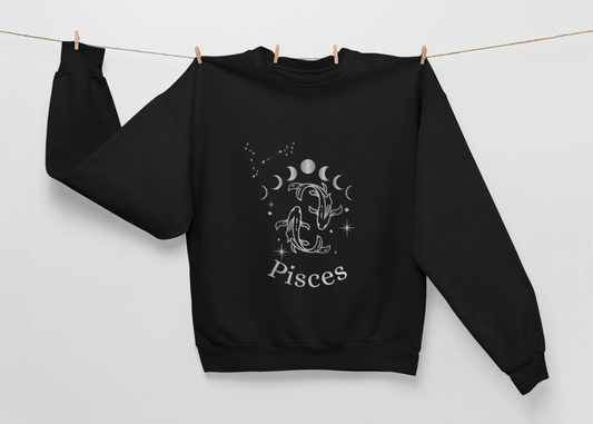 Black Ethereal Exile Pisces sweatshirt with silver-ink Pisces fish, moon phases, and constellation design, heavyweight cotton-poly blend with brushed fleece lining.
