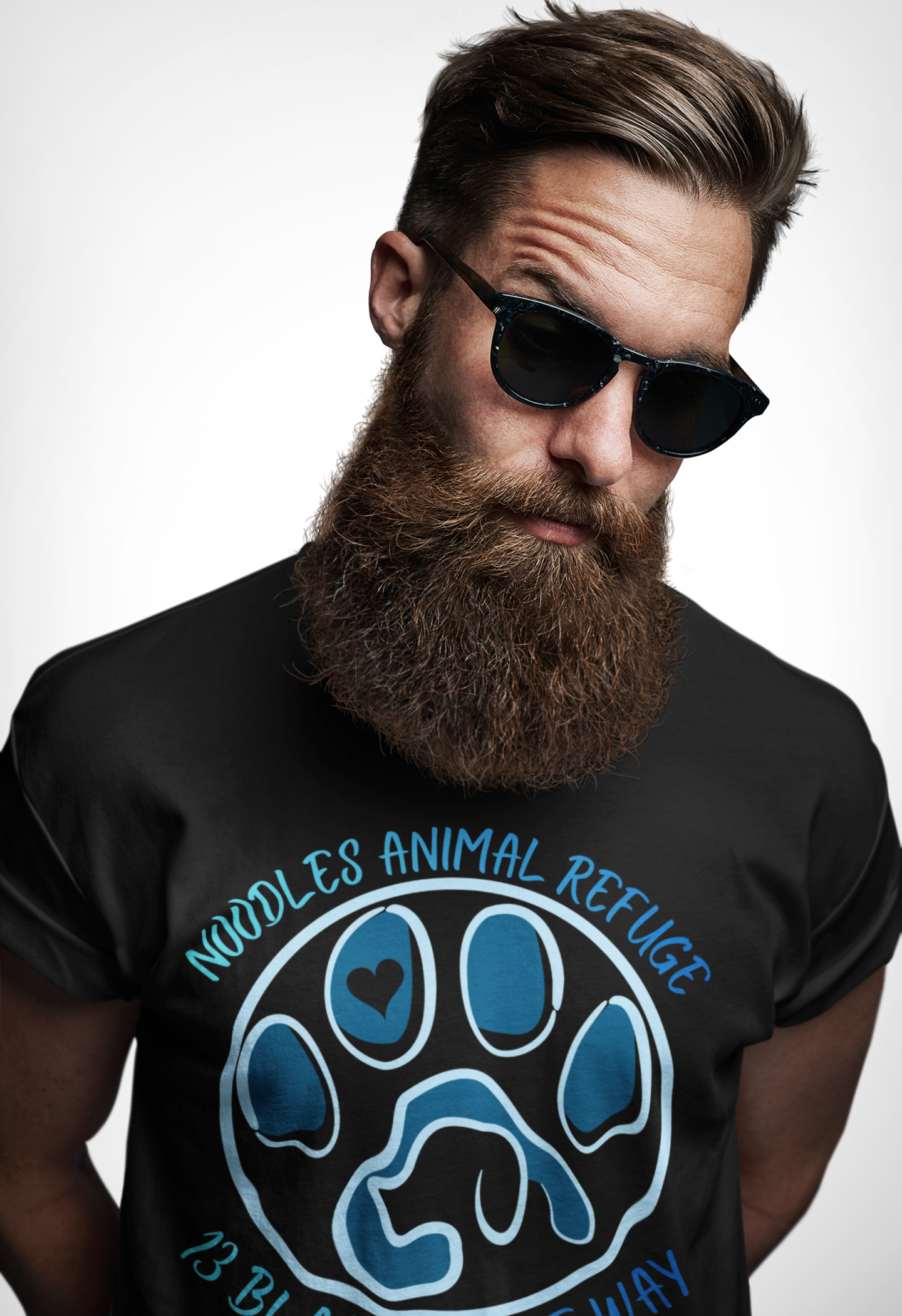 Man wearing black "Look Good, Do Good" tee with Noodles Animal Refuge paw logo and 13 Blackheart Way text.