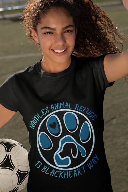 Young woman wearing black Look Good Do Good Tee with Noodles Animal Refuge paw logo holding a soccer ball outdoors