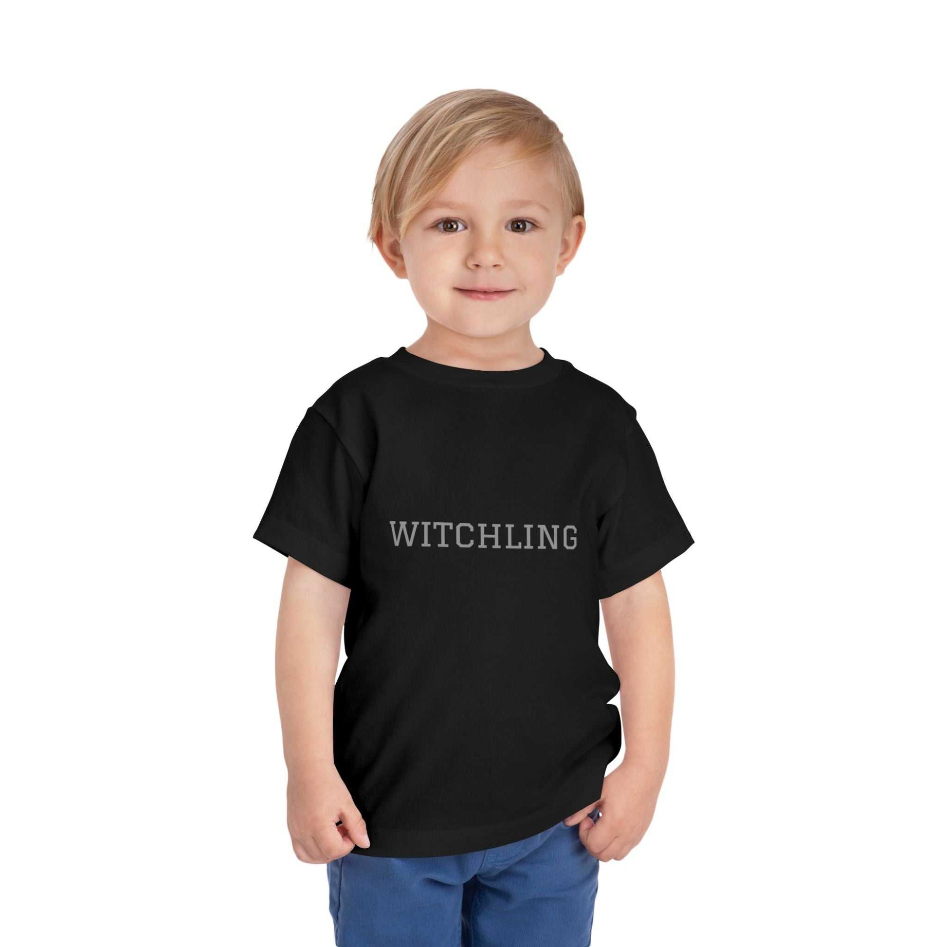 Witchling Toddler Short Sleeve Tee in black, 100% cotton, worn by child.