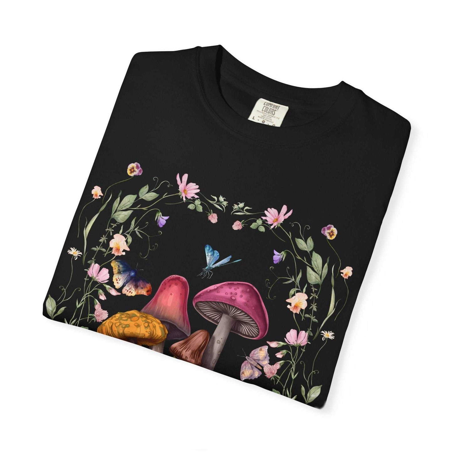 Mushroom Flower T-shirt with whimsical mushroom and floral design on folded black fabric.