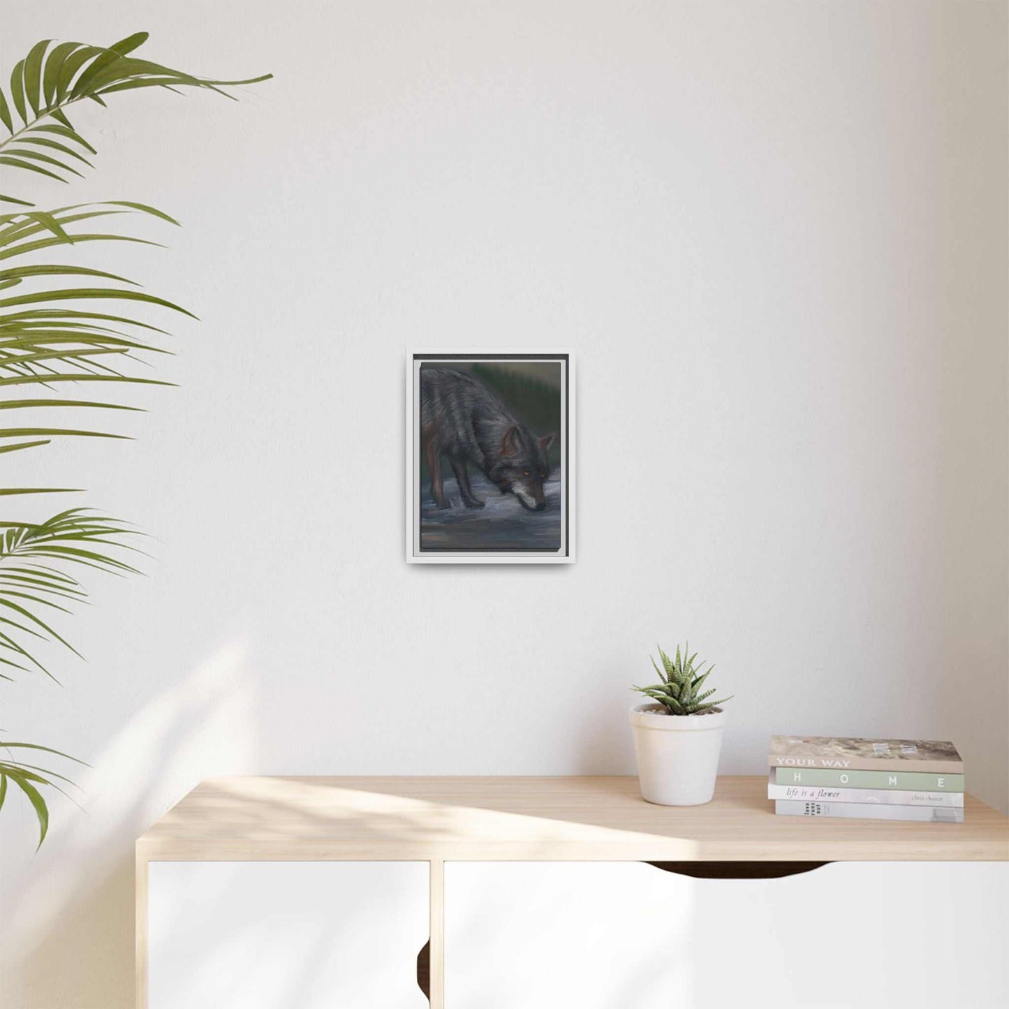 Nature-inspired framed wolf canvas art hanging on a minimalist wall.