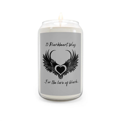 Blackheart Way Scented Candle in glass jar with lit wick, featuring decorative heart design.